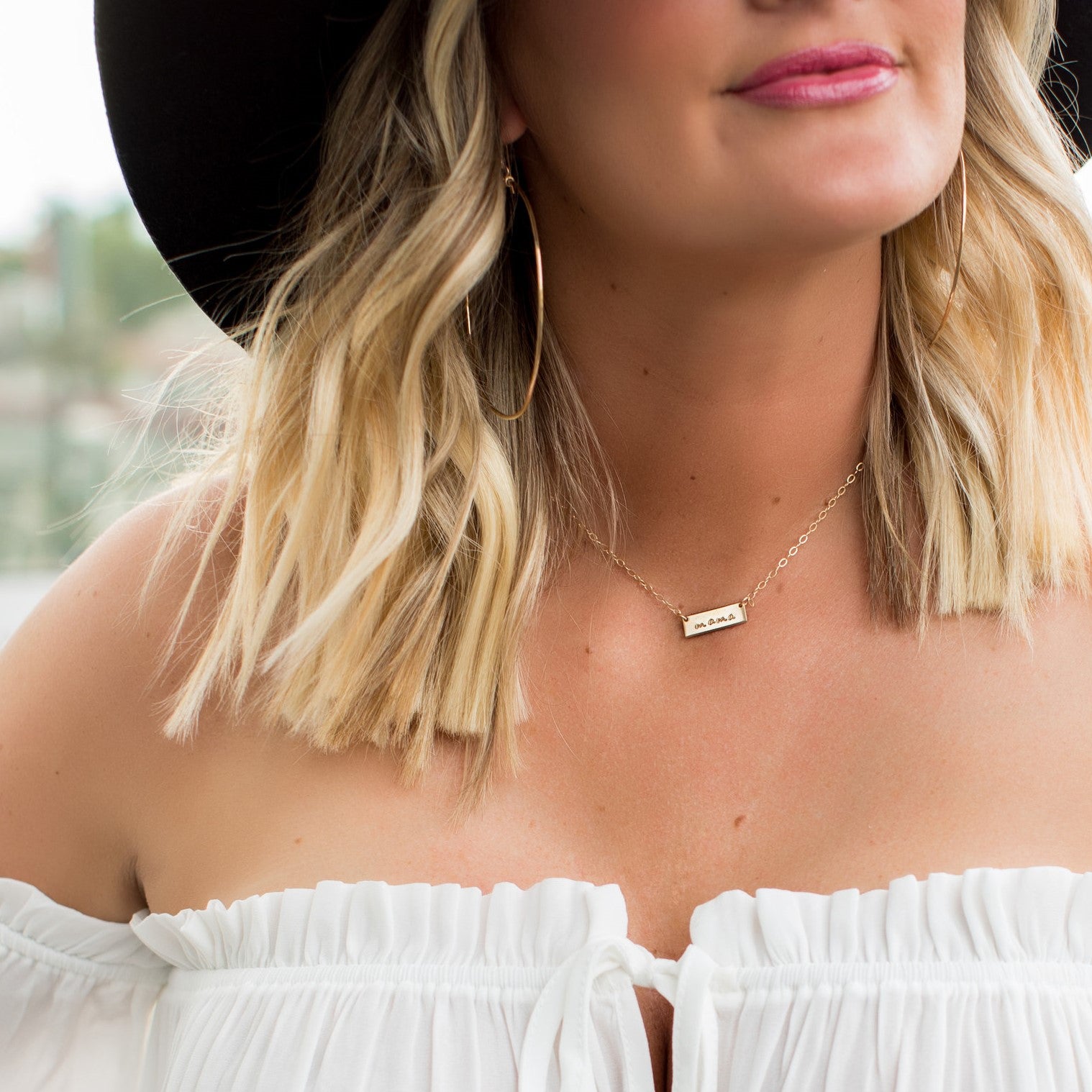 This is the tiny bar necklace hand stamped with "mama" in our most popular script font.