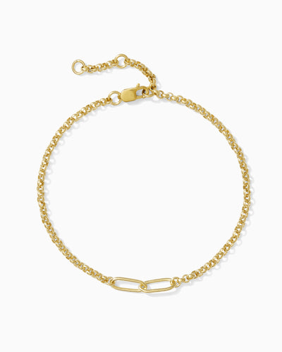 Gold chain with interlocking paperclip design bracelet on a white background.